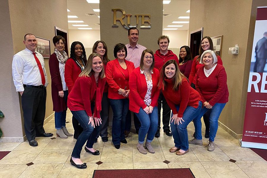 About Our Agency - Rue Insurance Team Celebrating Heart Health Awareness Month in the Office