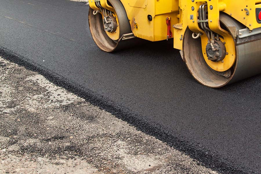 Asphalt and Concrete Contractors Association - View of a Paving Truck Smoothing Out New Asphalt on the Road