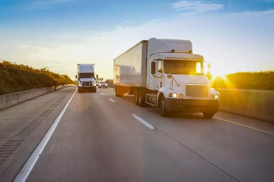Trucking-Insurance-Two-Trucks-Rolling-Down-the-Highway