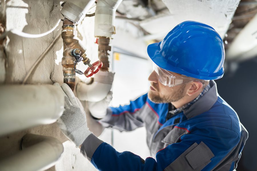 Contractors for Heating, Air Conditioning, Mechanical & Plumbing (CHAMP) - Male Worker Inspecting Valve