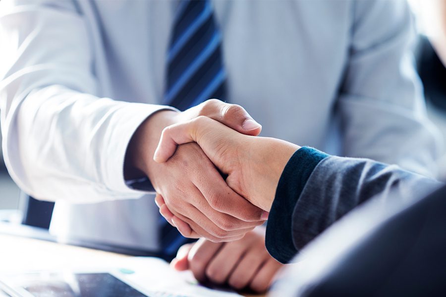 Referred By a Friend - Close-up of Two Business Partners Shaking Hands